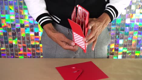 man unboxing valentines day card with intricate design