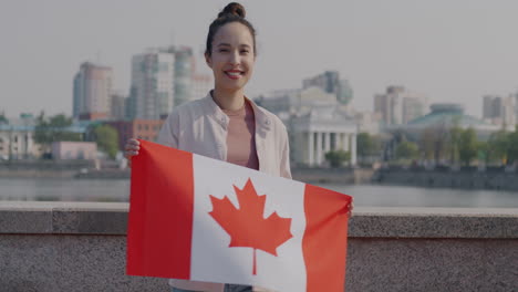 woman holding canadian flag in a city