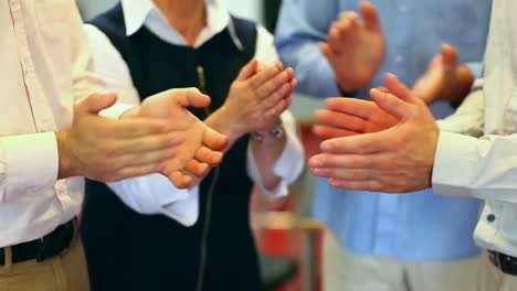 mature students clapping in the hallway