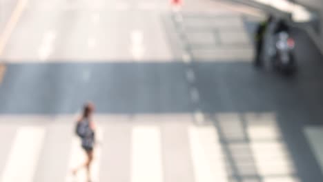 pedestrians and vehicles crossing city intersection