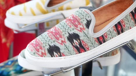 close-up view of patterned slip-on shoes on display