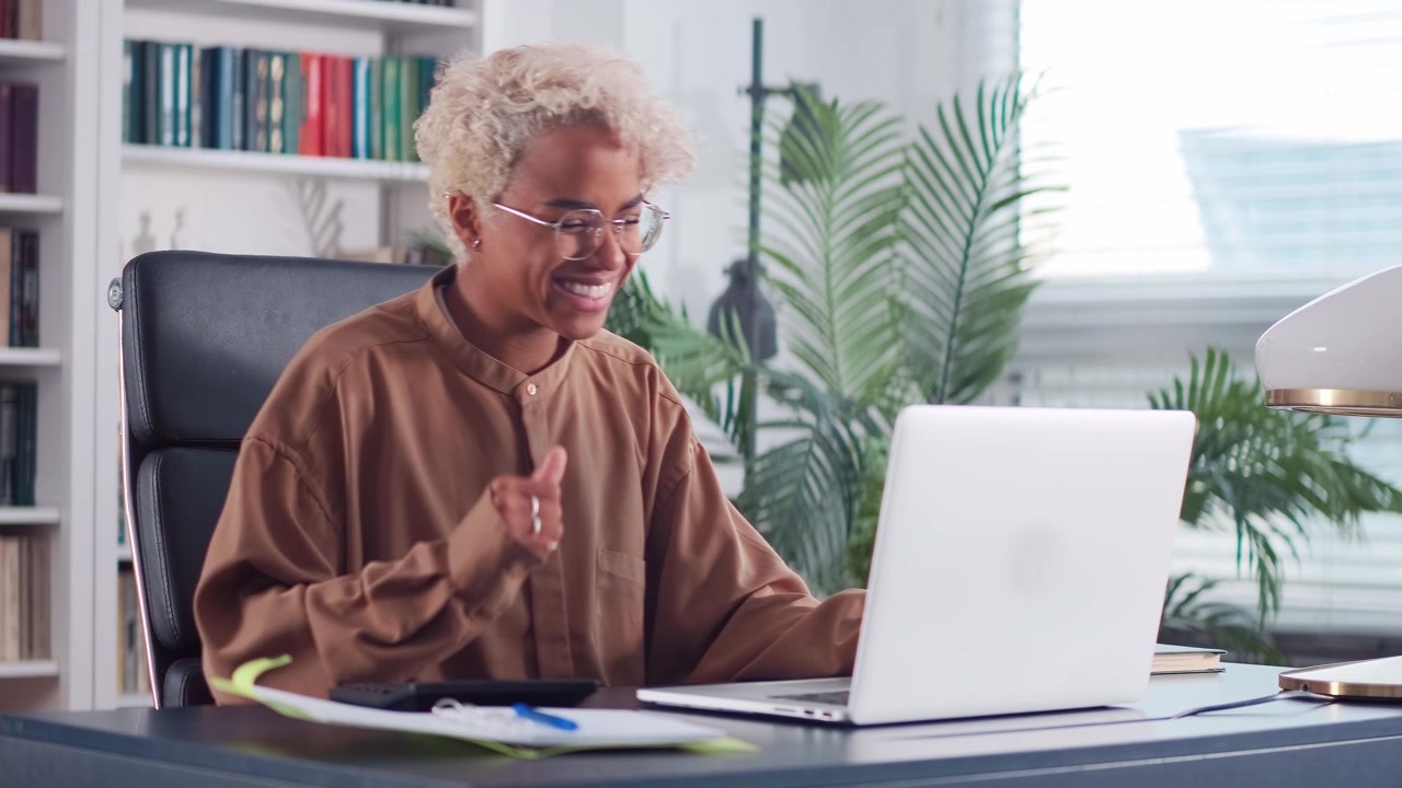 Overjoyed african american business woman with calculator in office