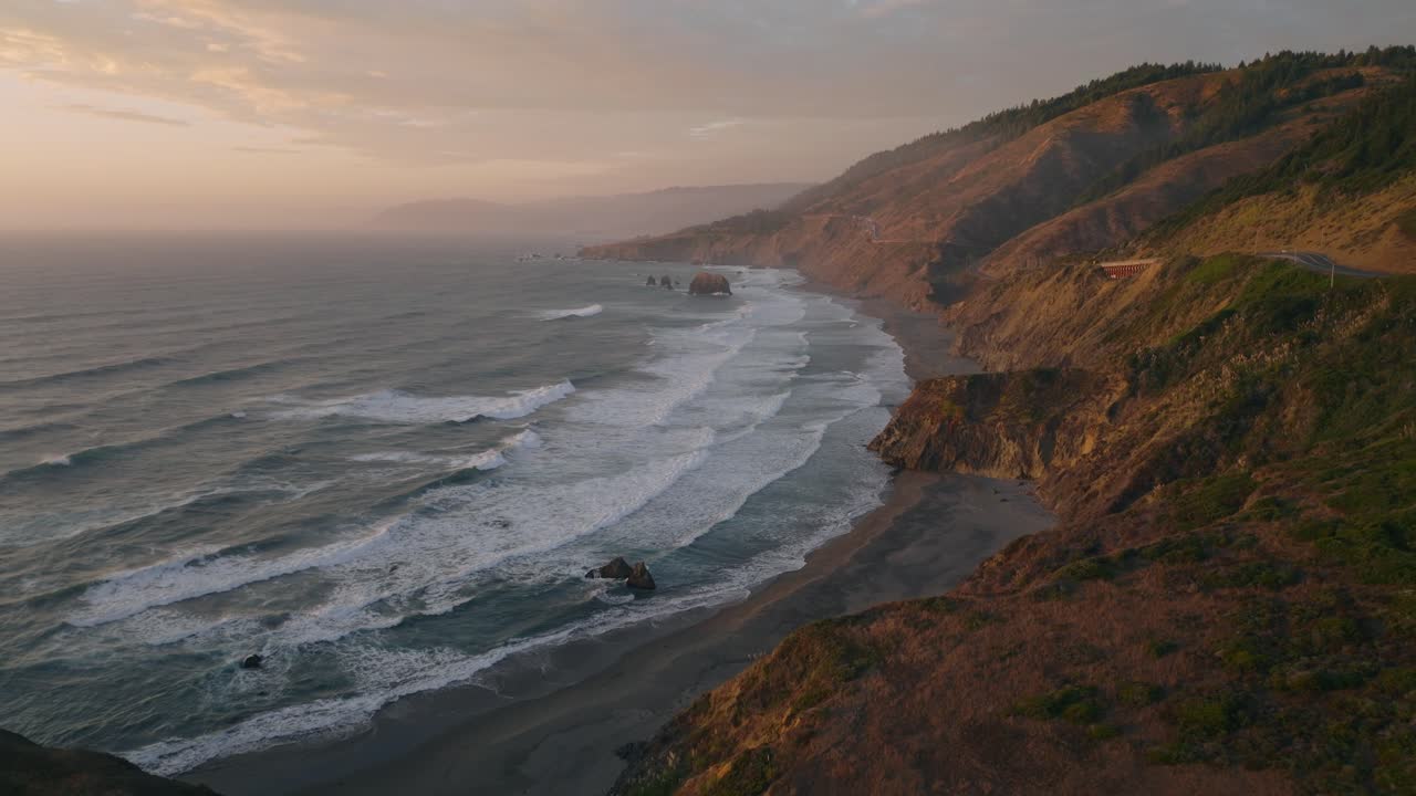 Scenic aerial view of California's iconic coastal Highway 1 at sunset