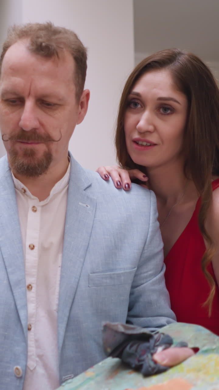 Artistic cooperation between man and woman. Woman muse in elegant red gown serves as inspiration breathing life in artist work. Creating masterpiece