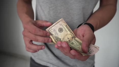 man counting two hundred dollars