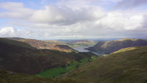 panning view over the fells of the lake district looking toward ullswater and glenridding on a bright cloudy day