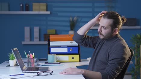 handsome young business man looking at his hair, smug.