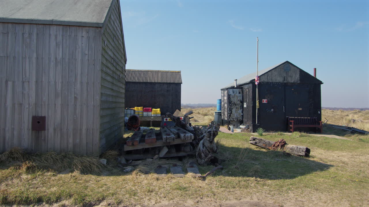 Panning Shot of fishing huts on winterton dunes next to Winterton on Sea,