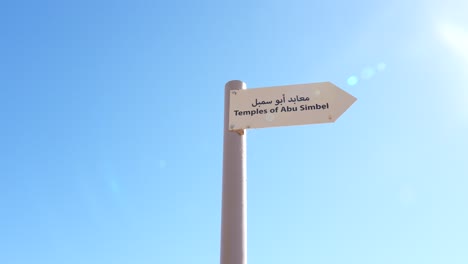 Panning shot of a guide sign at Abu Simbel in Egypt, sign points right