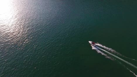 Aerial-drone-footage-following-motorboats-on-Lake-Biel-and-showing-off-the-blue-waters-and-gorgeous-scenery