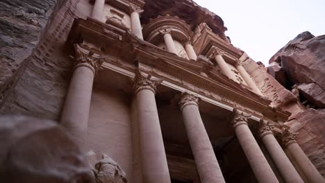 low-angle view of petra’s treasury, al-khazneh, iconic rose-red facade, jordan.