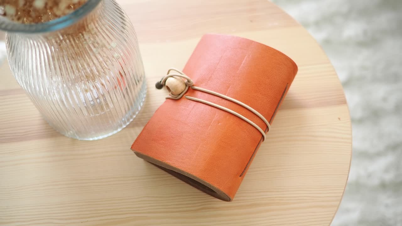 Leather Notebook with Elastic Band on a Wooden Table