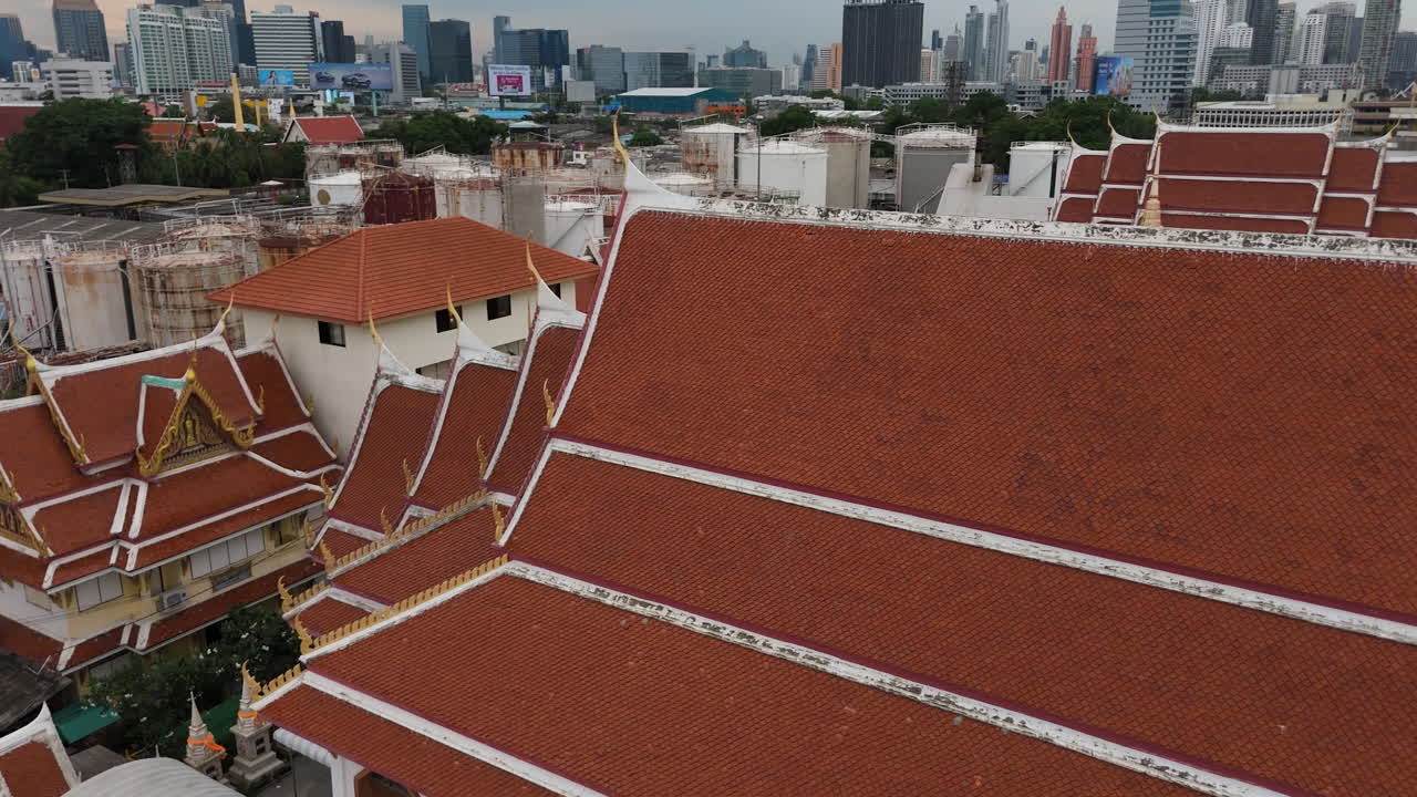 Traditional Thai Temple Wat Khlong Toei Nok With Ornate Exterior In Bangkok, Thailand. ascending drone, panning shot