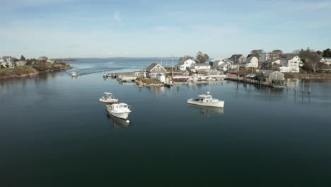 coastal fishing village with boats in large tide pool, drone shot