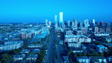 Parallax-flyover-aerial-104-Ave-top-view-drone-quiet-street-overlooking-low-rise-residential-buildings-on-route-to-the-downtown-city-mirrored-glass-windows-Rogers-oil-drop-oilers-building-summer-4k60