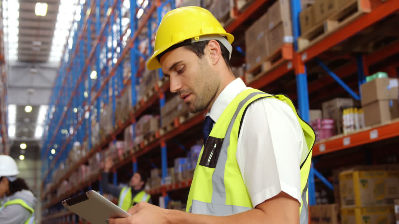 Magazziniere che usa il suo tablet