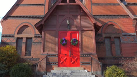 st michael's episcopal church main entrance door is decorated with christmas garlands in naugatuck, connecticut, united states