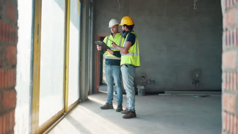 construction workers reviewing plans on a construction site