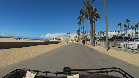 First-person-view-of-a-person-on-a-beach-cruiser,-on-the-bike-path,-in-Huntington-Beach-California