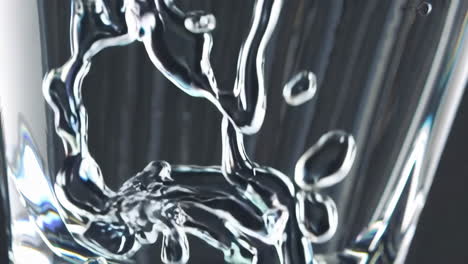 dynamic close-up of water pouring into a glass