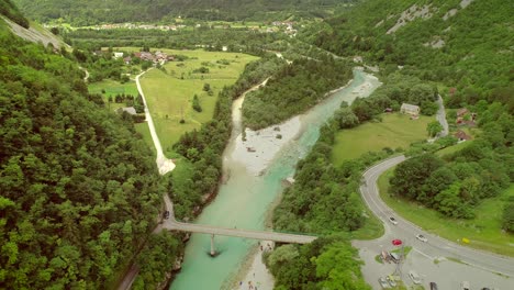 aerial view of a group of people doing rafting going under a bridge.