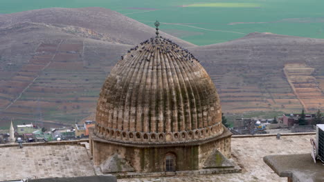 mardin's ulu camii's dome over looking mesopotamia on a cloudy day after rain