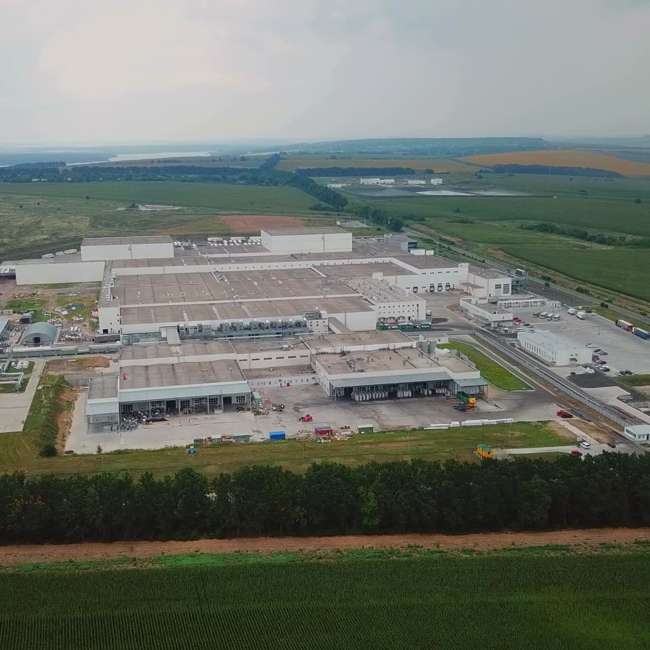 Aerial view of warehouse with trucks. Industrial background. Logistics from above