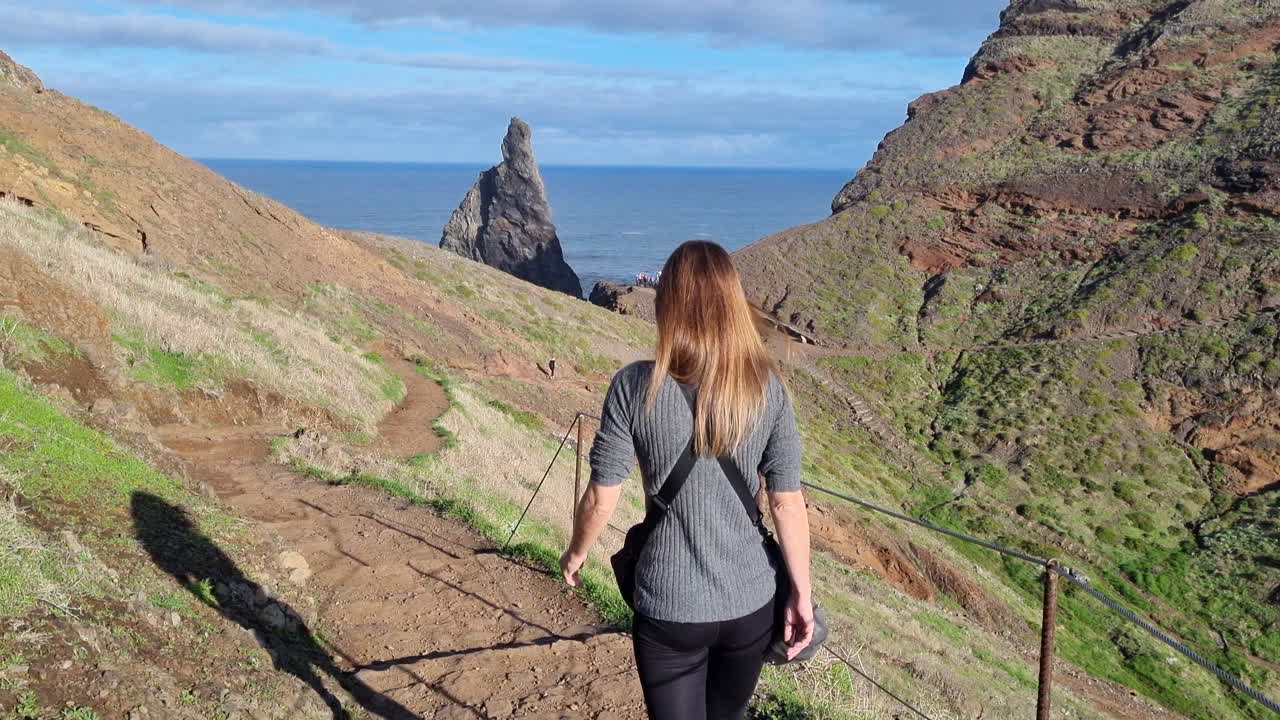 bonita foto de una mujer de mediana edad caminando por los senderos de la llamada ponta de são lorenzo, en la isla de madeira, portugal