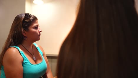 women enjoying a funny dinner with young friends inside a restaurant. static view