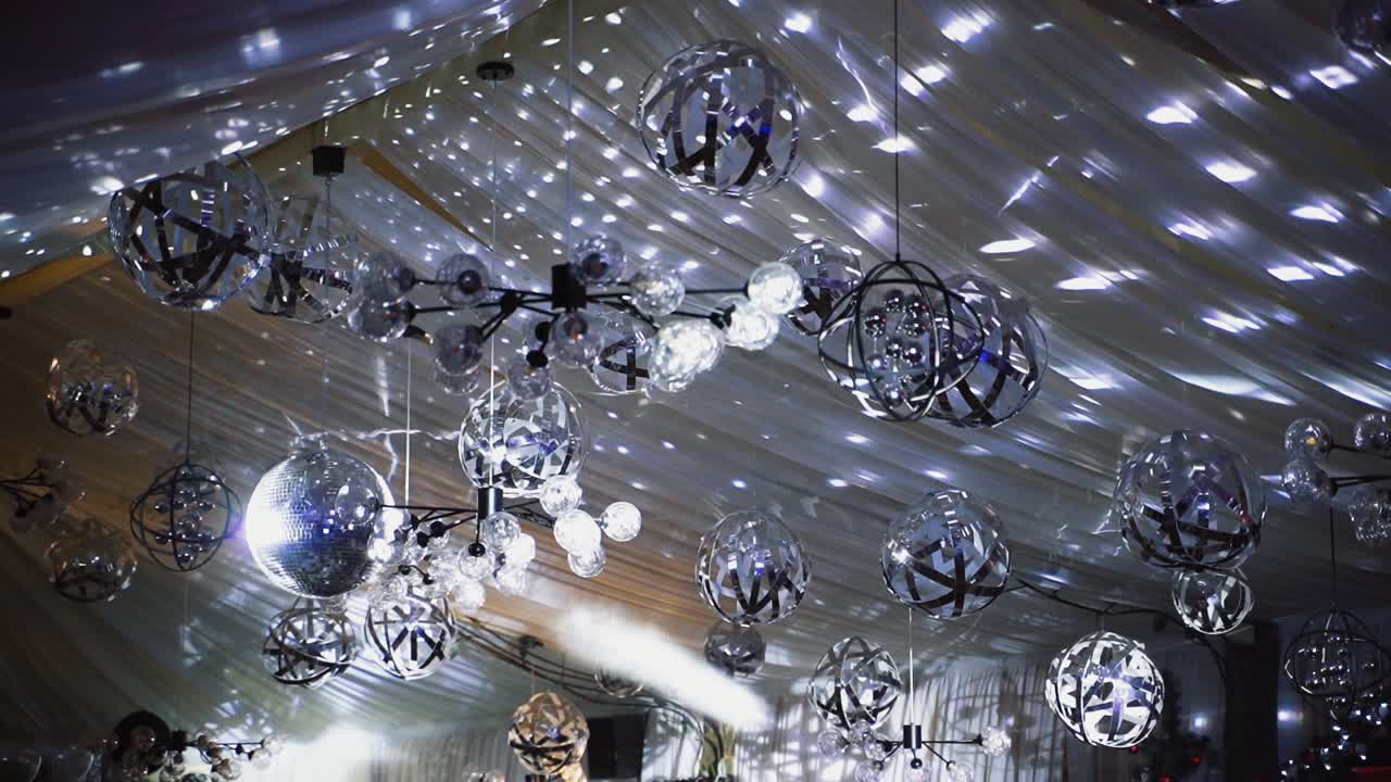 Rotating sparkling disco ball. Mirror disco ball reflecting lights background