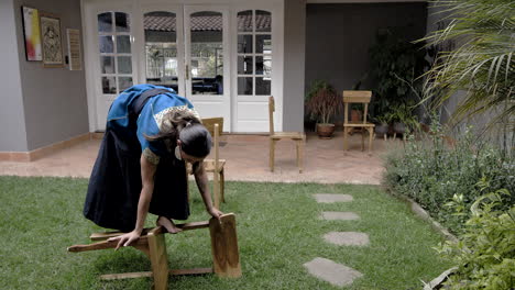 beautiful girl dancing among chairs in garden at home with andean typical dress, arty dancing art