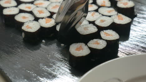 putting sushi rolls on the plate