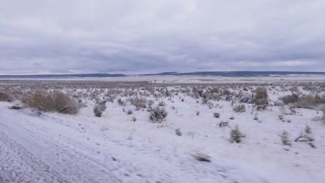 pov of driving in the desert at winter with snowy steppe fields