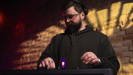 man with black cap djing at the disco