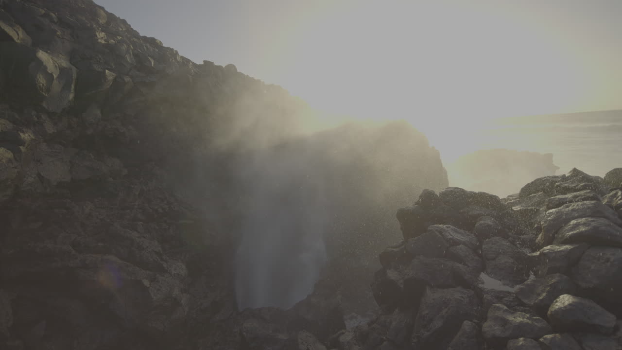 Powerful Ocean Waves Crashing Through Volcanic Rock Formations