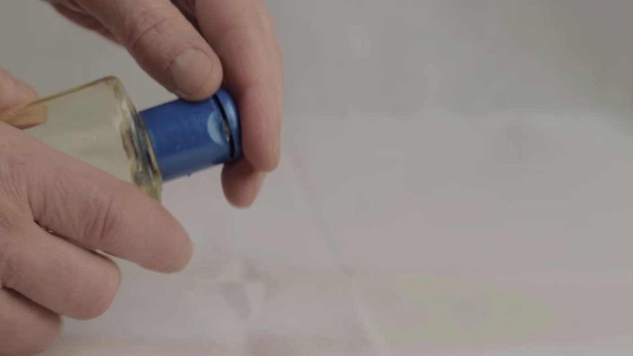 Hands using bottle of sanitizer gel medium shot