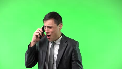 man on phone call expressing various emotions on green screen