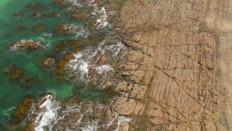 4k aerial rocky beach of south australia with turquoise water - drone overhead shot