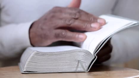 man praying to god with hands together with bible caribbean man praying with white background stock footage
