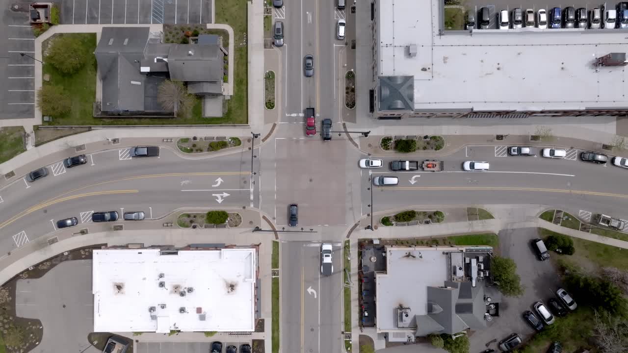 Traffic at an intersection in Ada Village in Ada, Michigan with drone video overhead looking down.