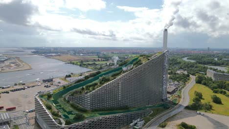 copenhill in copenhagen, denmark, blends a waste-to-energy plant with an urban ski slope, hiking trails, and green spaces, creating a landmark for sustainability and recreational innovation