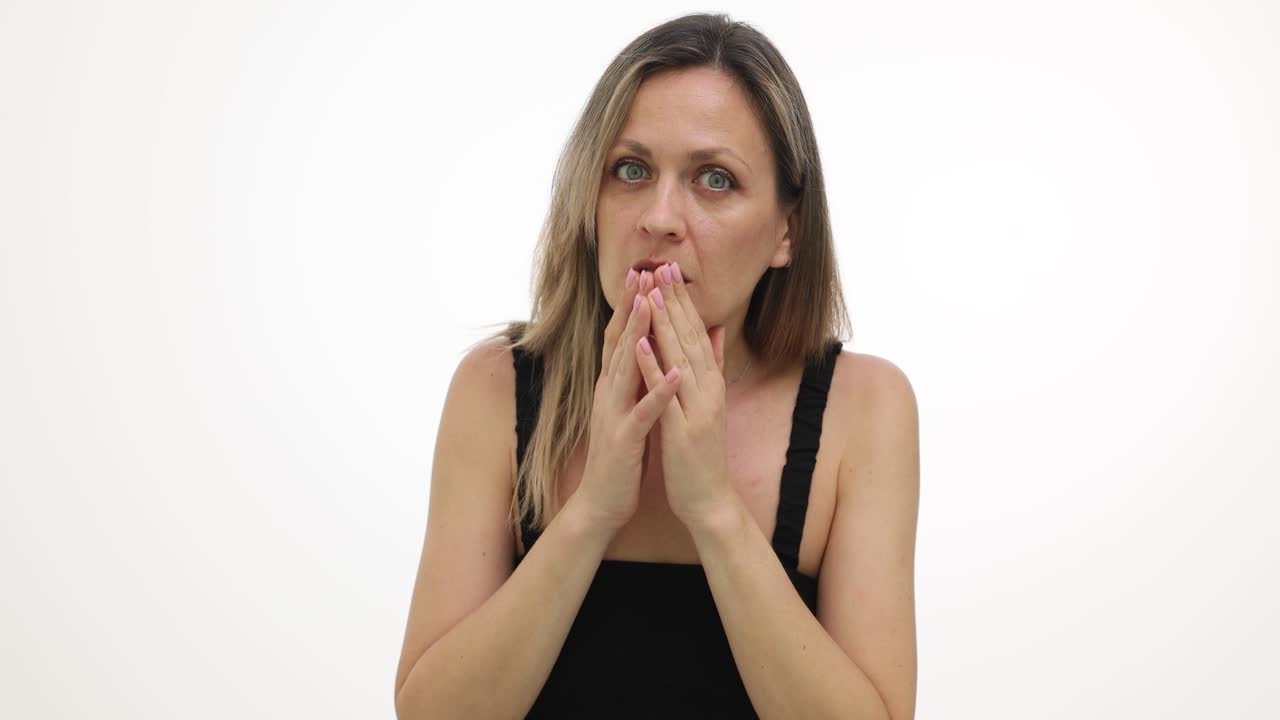 A woman expresses surprise and anxiety with hand gestures