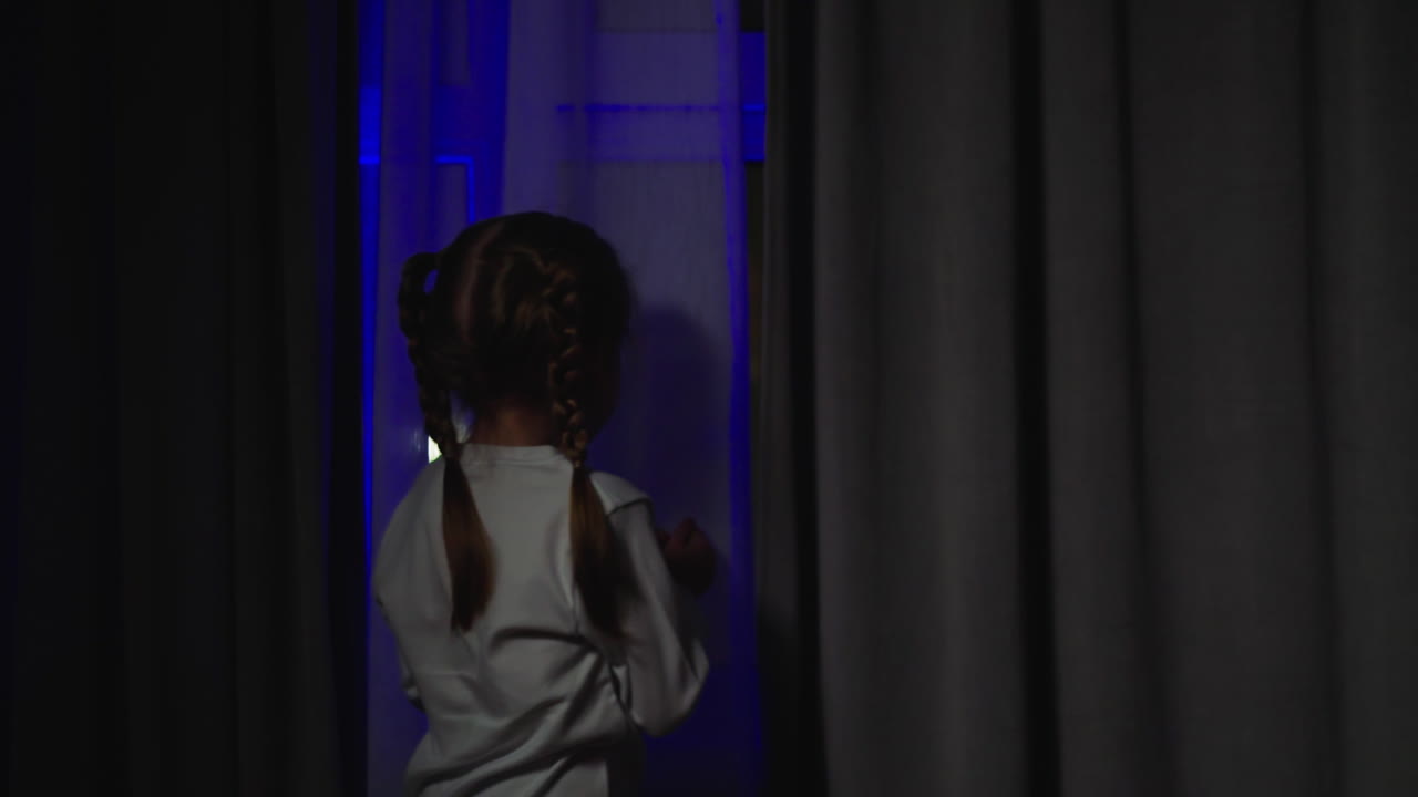 Scared girl looks out of window at accident and flashlights
