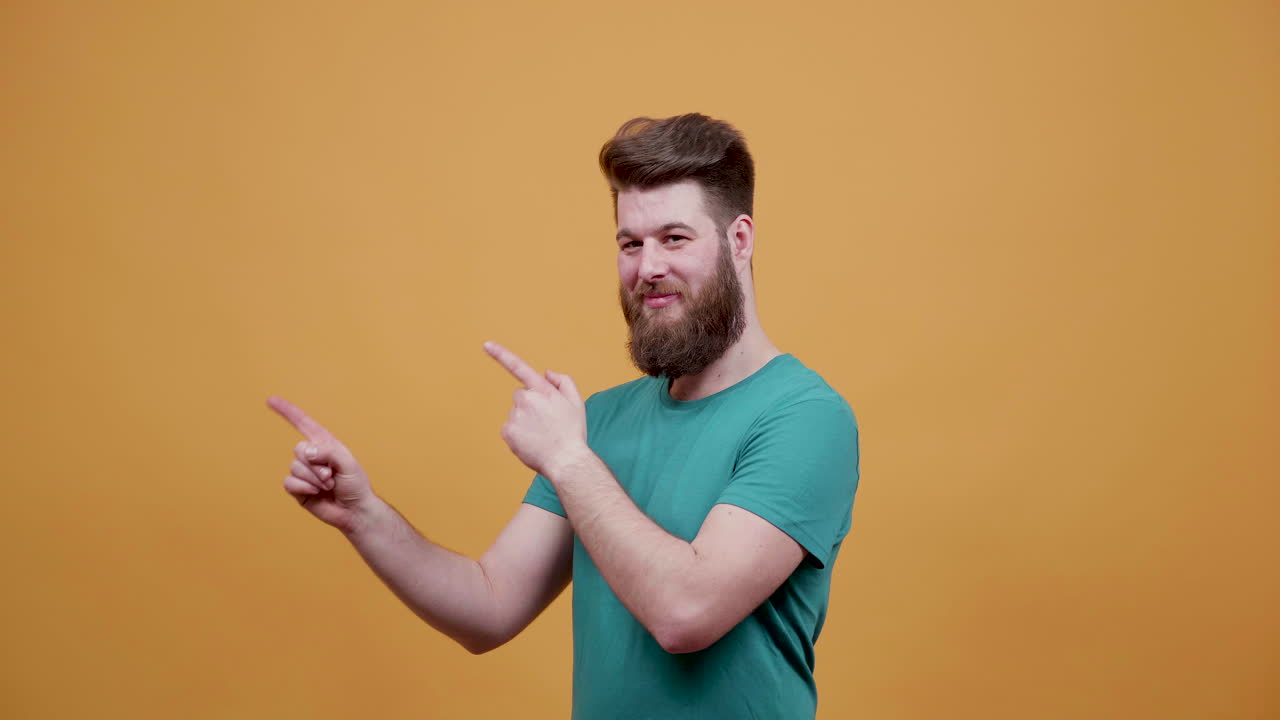 Man with beard pointing to the side
