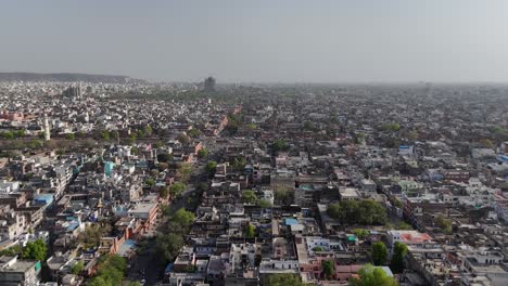 aerial shot capturing the striking contrast between rugged hills and dense city life.