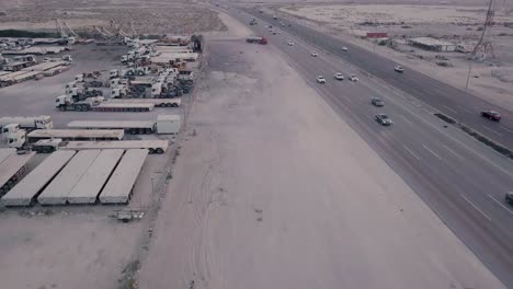 industrial vehicle yard with desert highway