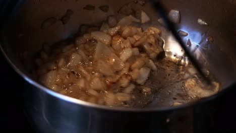 Stirring-and-browning-of-diced-onions-in-a-stainless-pan-CLOSE-UP