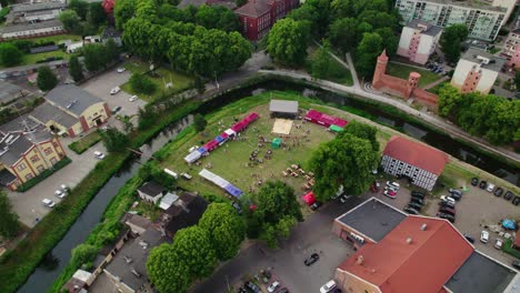 drone parallax footage of a city with curved river during festival