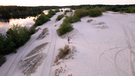 young couple walking on sand