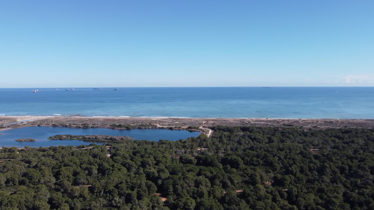 4K Drone View of Mediterranean Forest, Lagoon with Island, and Mediterranean Sea with Cargo Ships